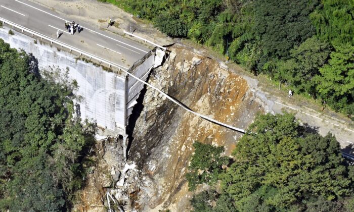 A collapsed road following a typhoon in Morotsuka, Miyazaki prefecture, Japan, on Sept. 20, 2022. (Kyodo News via AP)