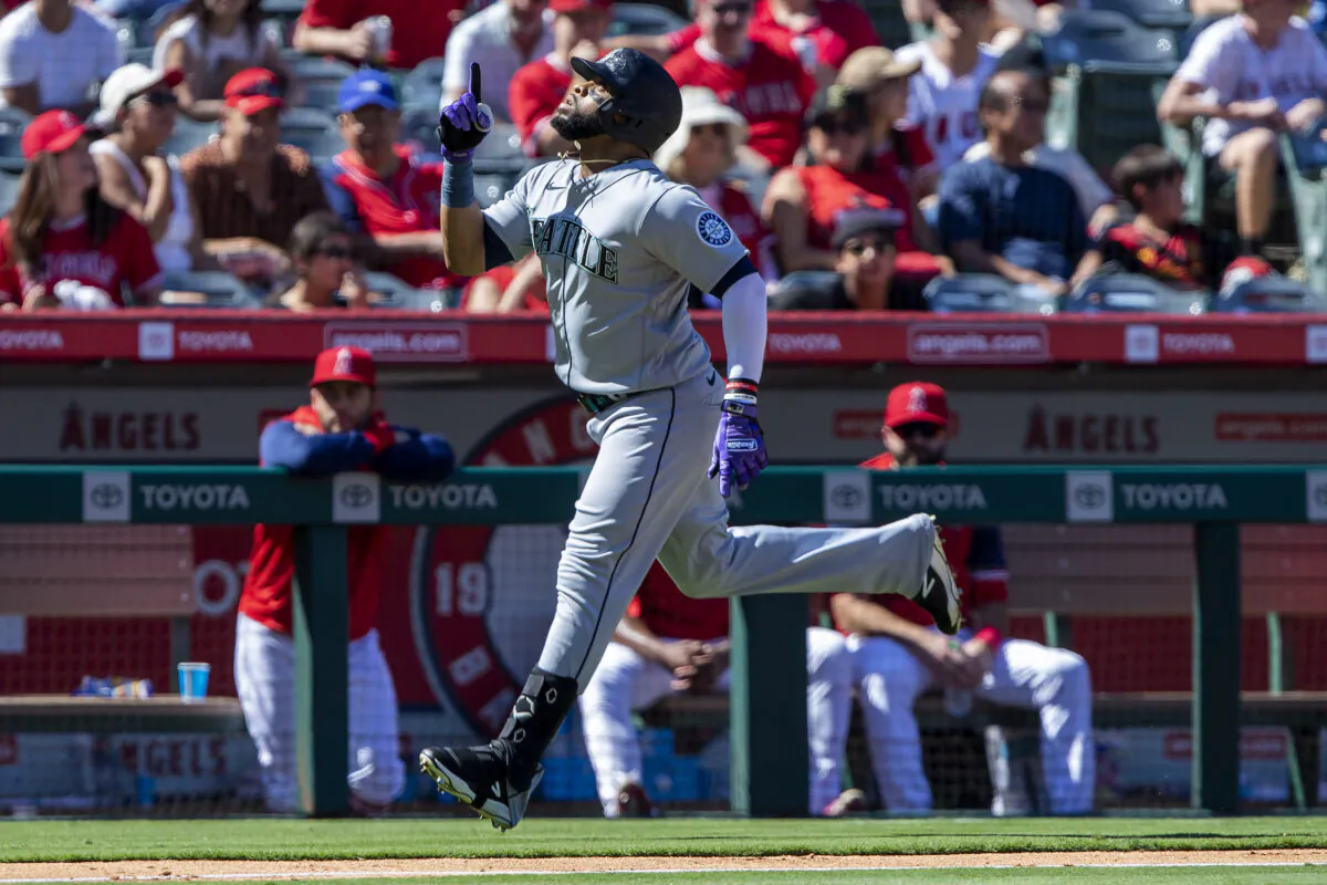 Seattle Mariners' Carlos Santana points skyward while rounding the bases after hitting a grand slam against the Los Angeles Angels during the fifth inning of a baseball game in Anaheim, Calif., on Sept. 19, 2022. (Alex Gallardo/AP Photo)