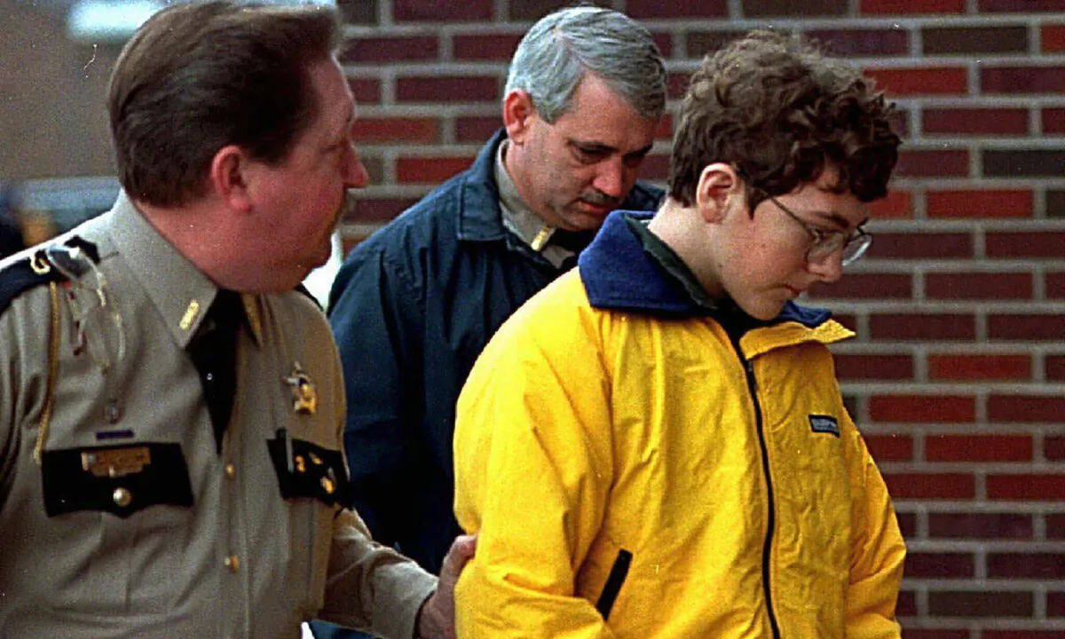 Heath High School shooting suspect Michael Carneal is escorted out of the McCracken County Courthouse after his arraignment in Paducah, Ky., on Jan. 15, 1998. (Sam Upshaw Jr./Courier Journal via AP)
