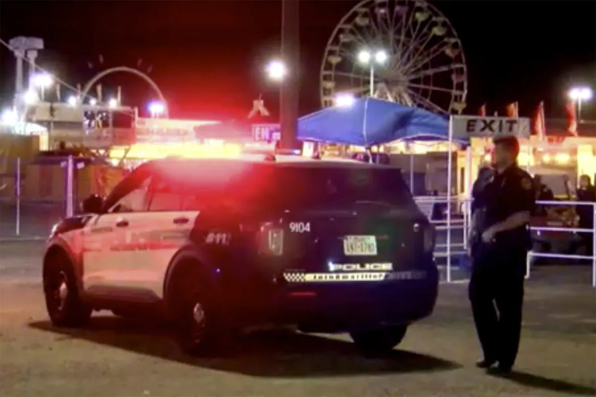 A police officer stands beside a police car near a shooting scene in Amarillo, Texas on Sept. 19, 2022, in an image made from video. (KVII via AP)