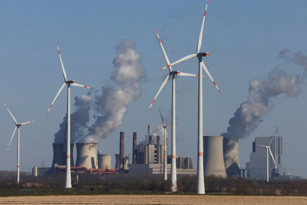 Wind power stations of German utility RWE, one of Europe's biggest electricity companies, in front of RWE's brown coal-fired power plants of Neurath near Jackerath, northwest of Cologne, Germany, on Mar. 18, 2022. (Wolfgang Rattay/Reuters)