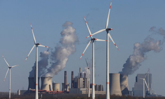 Wind power stations of German utility RWE, one of Europe's biggest electricity companies, in front of RWE's brown coal-fired power plants of Neurath near Jackerath, northwest of Cologne, Germany, on Mar. 18, 2022. (Wolfgang Rattay/Reuters)