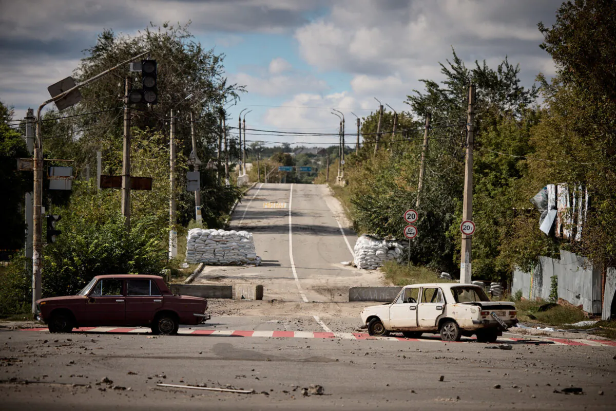 Damaged cars in the town of Kupiansk in Kharkiv region, Ukraine, on Sept. 19, 2022. (Ukrainian Presidential Press Service/Handout via Reuters)
