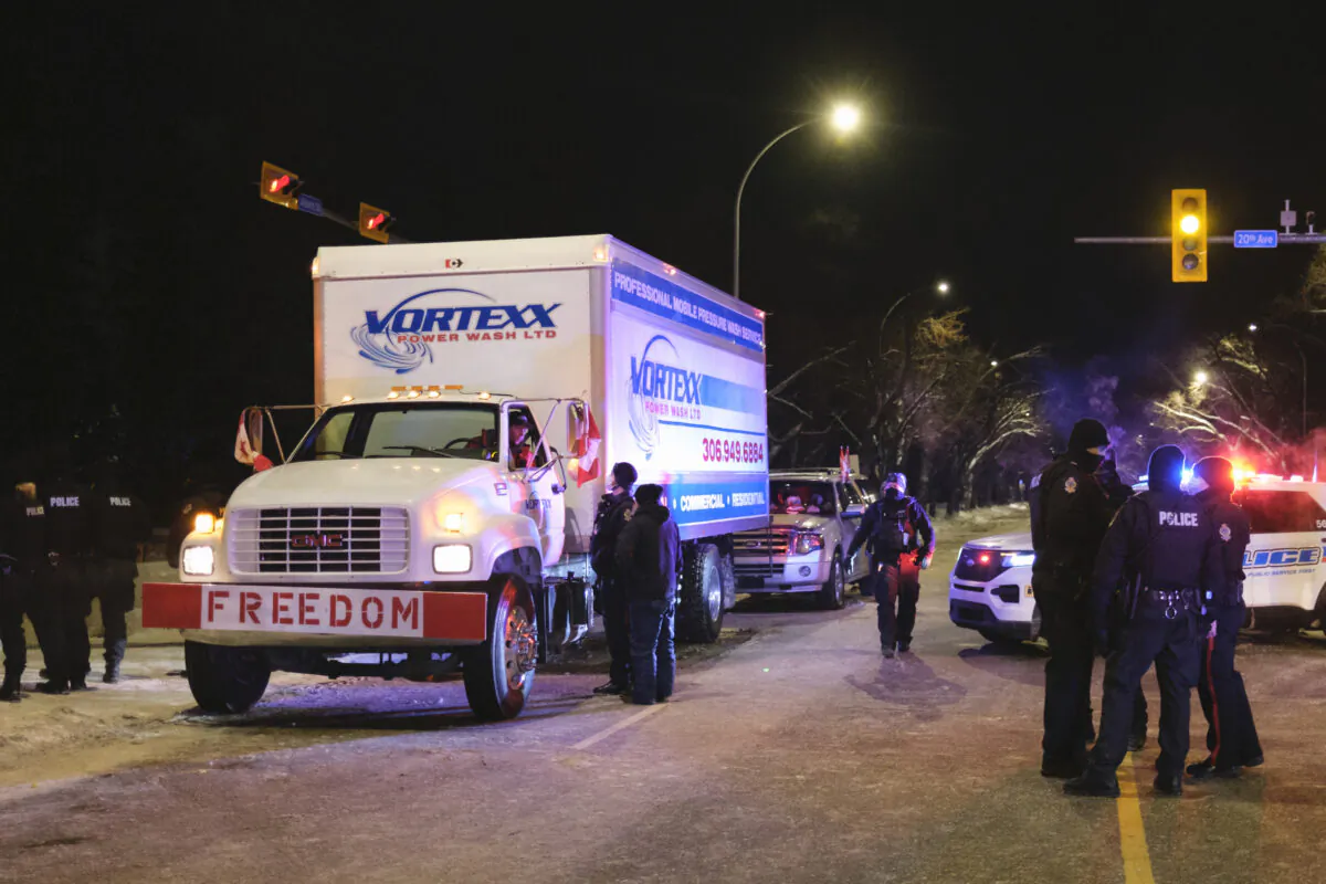 Police speak to the driver of a vehicle at a protest opposing pandemic public health orders near the Legislative Building in Regina on Feb. 6, 2022. (The Canadian Press/Michael Bell)