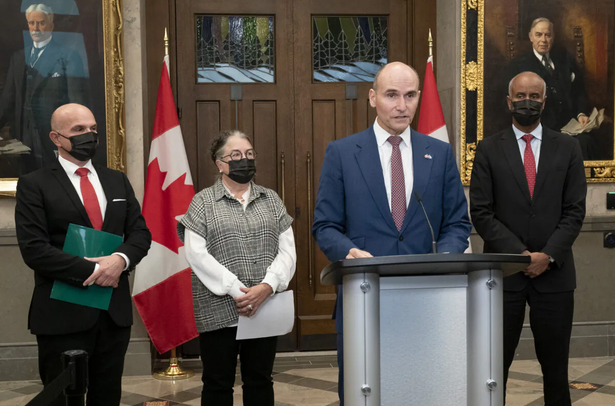 Minister of Tourism and Associate Minister of Finance Randy Boissonnault (L), Minister of National Revenue, Diane Lebouthillier, and Housing and Diversity and Inclusion Minister Ahmed Hussen (R), look on as Minister of Health Jean-Yves Duclos responds to questions from the media during a news conference on Parliament Hill on Sept. 20, 2022 in Ottawa. (Adrian Wyld/The Canadian Press)