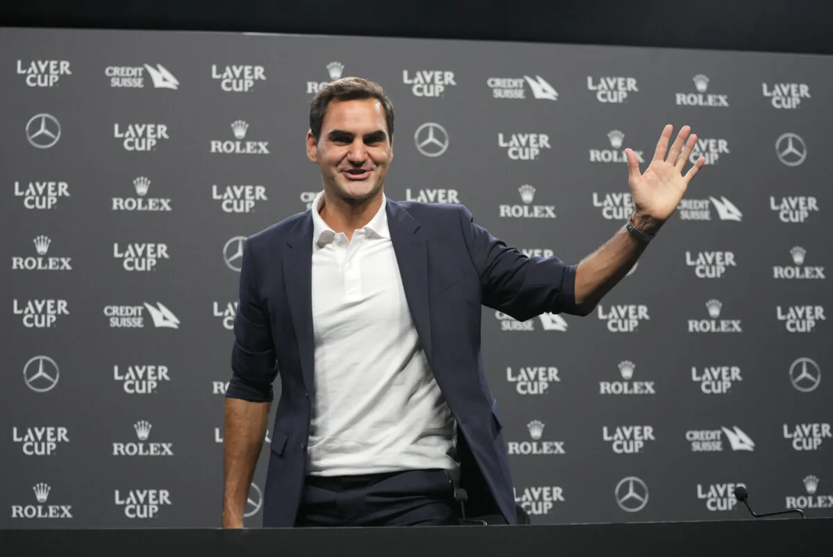 Switzerland's Roger Federer waves during a media conference ahead of the Laver Cup tennis tournament at the O2 in London, on Sept. 21, 2022.  (Kin Cheung/AP Photo)