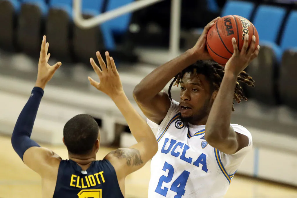 Jalen Hill #24 of the UCLA Bruins defends the rebound against Greg Elliott #5 of the Marquette Golden Eagles during the second half at UCLA Pauley Pavilion in Los Angeles on Dec. 11, 2020. (Katelyn Mulcahy/Getty Images)