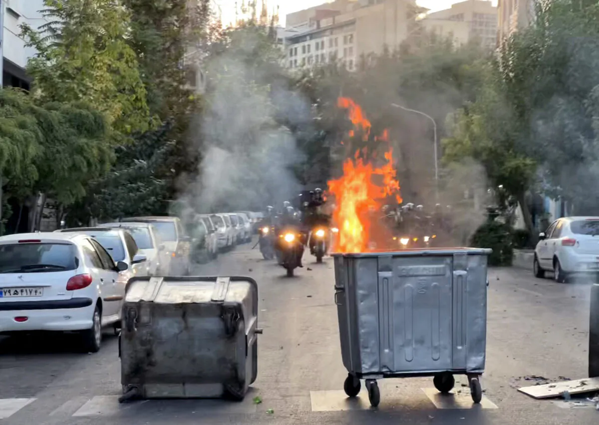 A bin burning in the middle of an intersection during a protest for Mahsa Amini, a woman who died after being arrested by the Islamic republic's "morality police," in Tehran on Sept. 20, 2022. (AFP via Getty Images)
