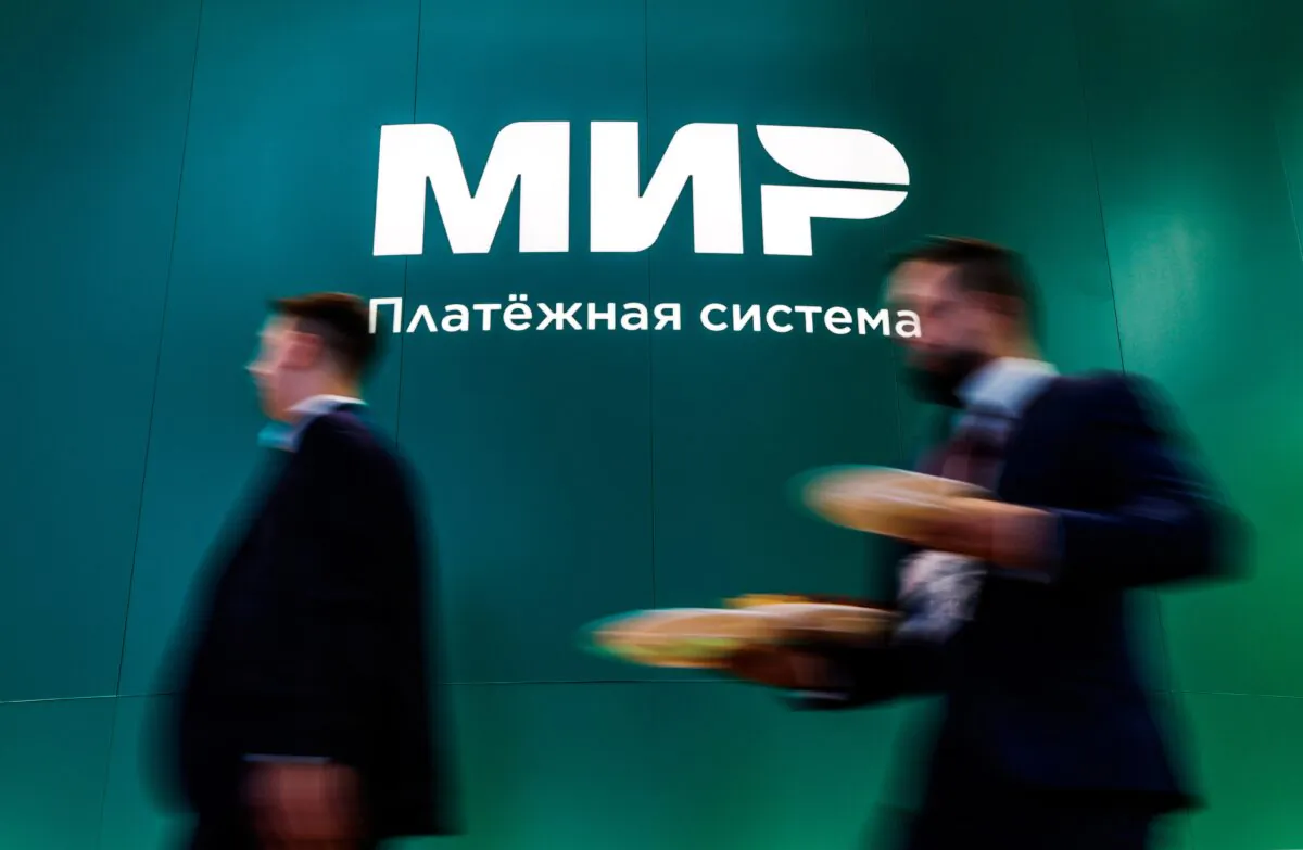 People walk past the logo of Russian payment system Mir at the St. Petersburg International Economic Forum (SPIEF) in Saint Petersburg, Russia, on June 15, 2022. (Maxim Shemetov/Reuters)