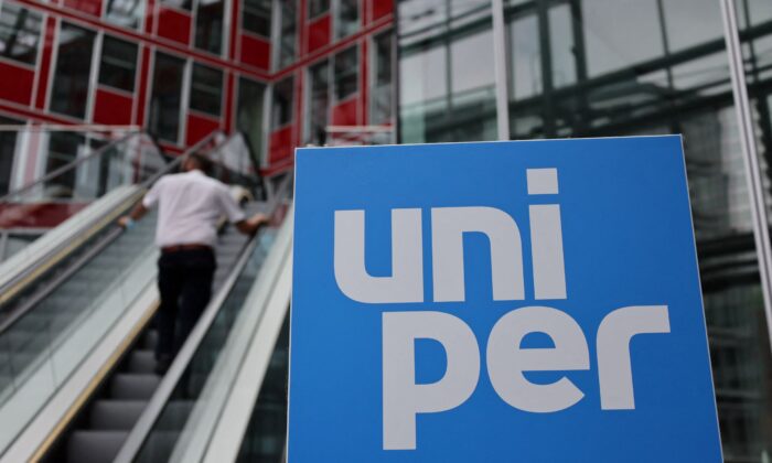 A person rides an escalator near the Uniper logo at the utility firm's headquarters in Duesseldorf, Germany, on July 8, 2022. (Wolfgang Rattay/Reuters)