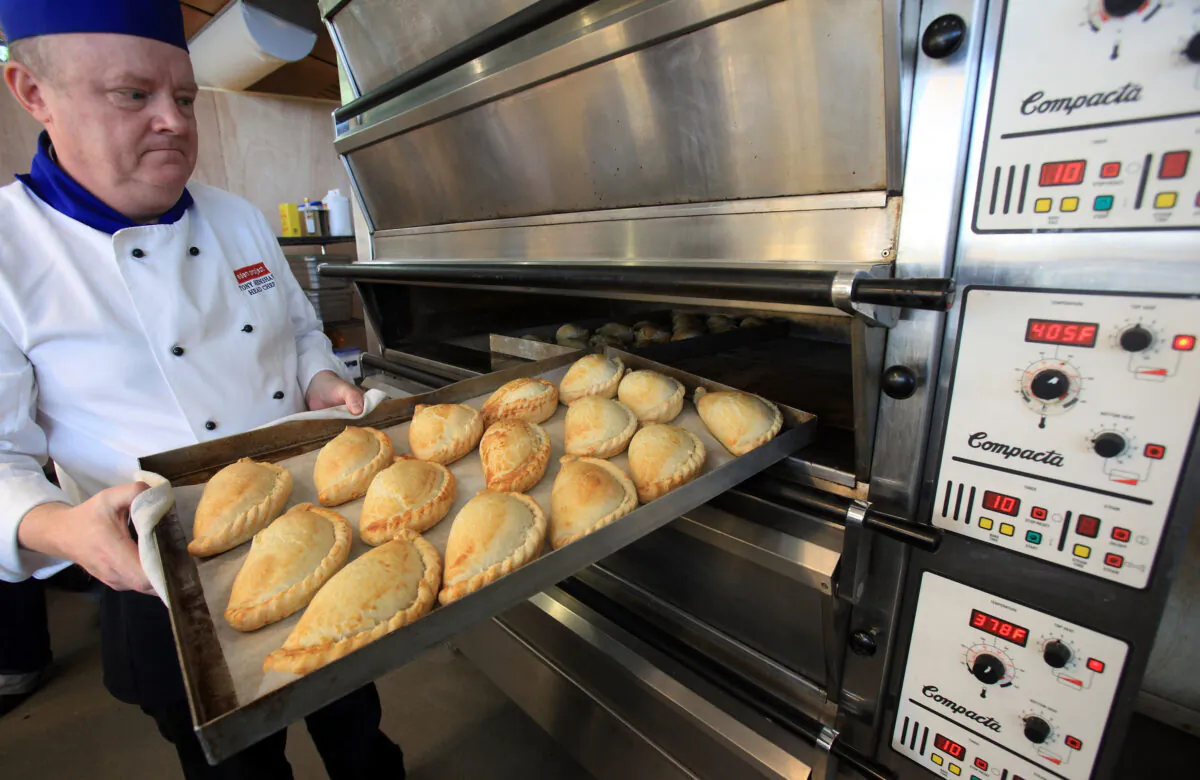 Head chef Tony Henshaw takes freshly baked pasties out of the oven, in St. Austell, England, on March 3, 2012. (Matt Cardy/Getty Images)