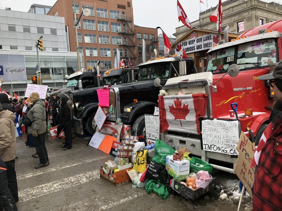 Food and necessities donated to truckers are left beside trucks parked near Parliament Hill in Ottawa on Feb. 6, 2022. (Noé Chartier/The Epoch Times)