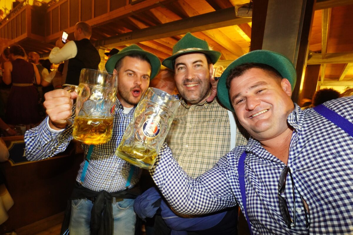 Revelers sing and hoist beer mugs in the Paulaner tent on the opening day of the Oktoberfest beer fest on Saturday, Sept. 17, 2022, in Munich, Germany. This year's Oktoberfest, which runs until Oct. 3 and is expected to draw more than a million visitors, is the first to take place since 2019. The past two years were closed down due to the coronavirus pandemic. (Johannes Simon/Getty Images/TNS)