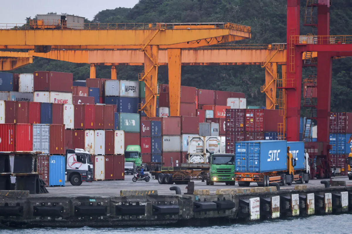 Cargo trucks work inside a container yard in Keelung, Taiwan, on Jan. 7, 2022. (Ann Wang/Reuters)