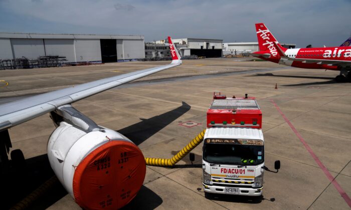 A Thai AirAsia aircraft engine is covered, after not being used during the coronavirus disease (COVID-19) pandemic, on the tarmac of Bangkok's Don Muang International Airport on Oct. 27, 2021. (Athit Perawongmetha/Reuters)
