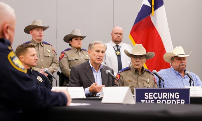 Texas Gov. Greg Abbott (C) is flanked by law enforcement personnel as he issues an executive order to designate Mexican cartels as terrorist organizations, in Midland, Texas, on Sept. 21, 2022. (Texas Governor's Office)