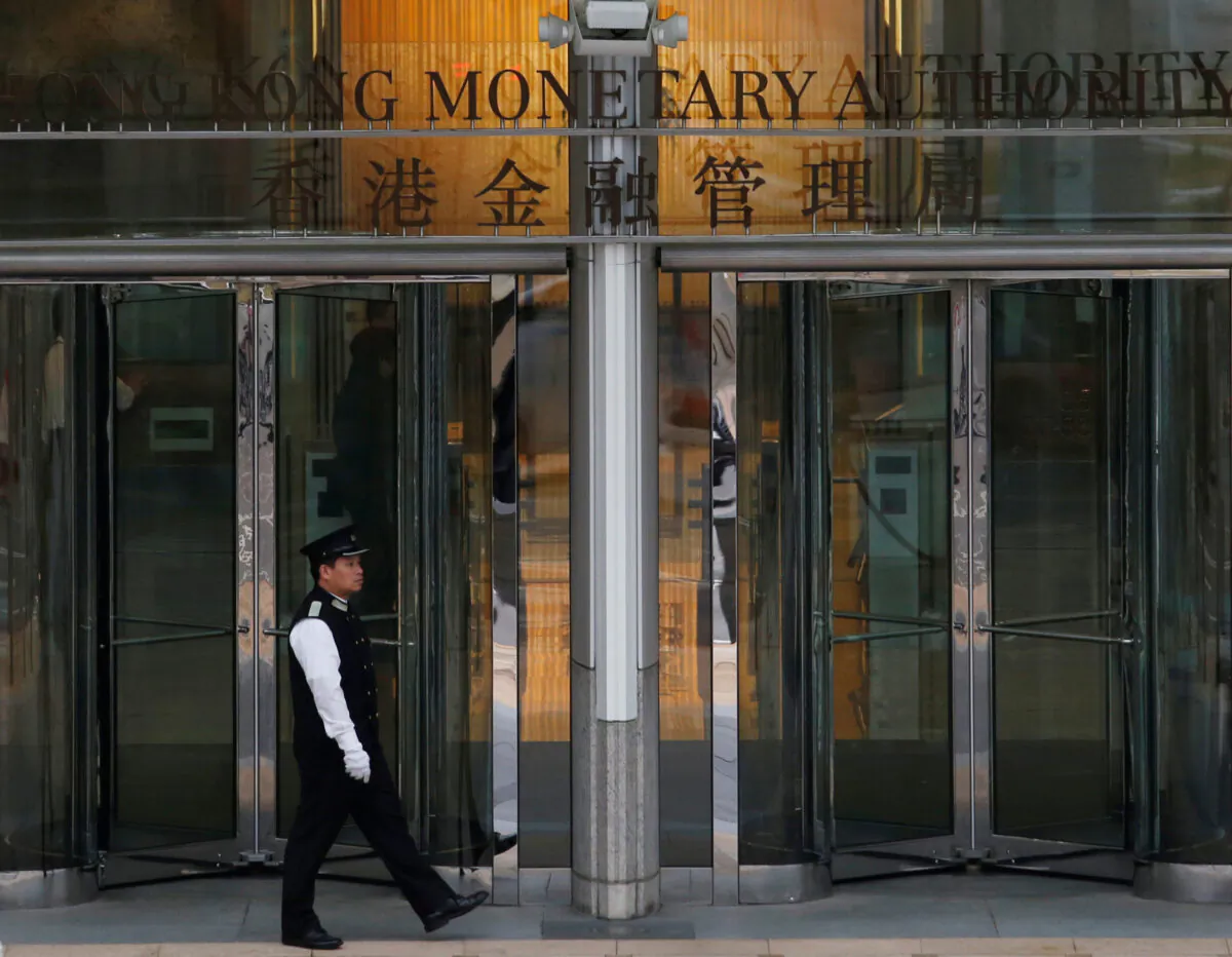 An attendant walks outside the entrance to Hong Kong Monetary Authority on Nov. 10, 2015. (Bobby Yip/Reuters)