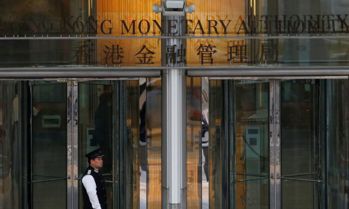 An attendant walks outside the entrance to Hong Kong Monetary Authority on Nov. 10, 2015. (Bobby Yip/Reuters)