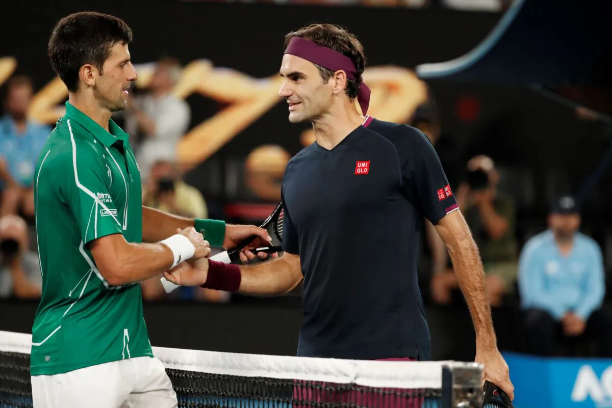 Serbia's Novak Djokovic and Switzerland's Roger Federer (R) shake hands after their match of Australian Open at Melbourne Park in Melbourne, Australia, on Jan. 30, 2020. (Issei Kato/Reuters)