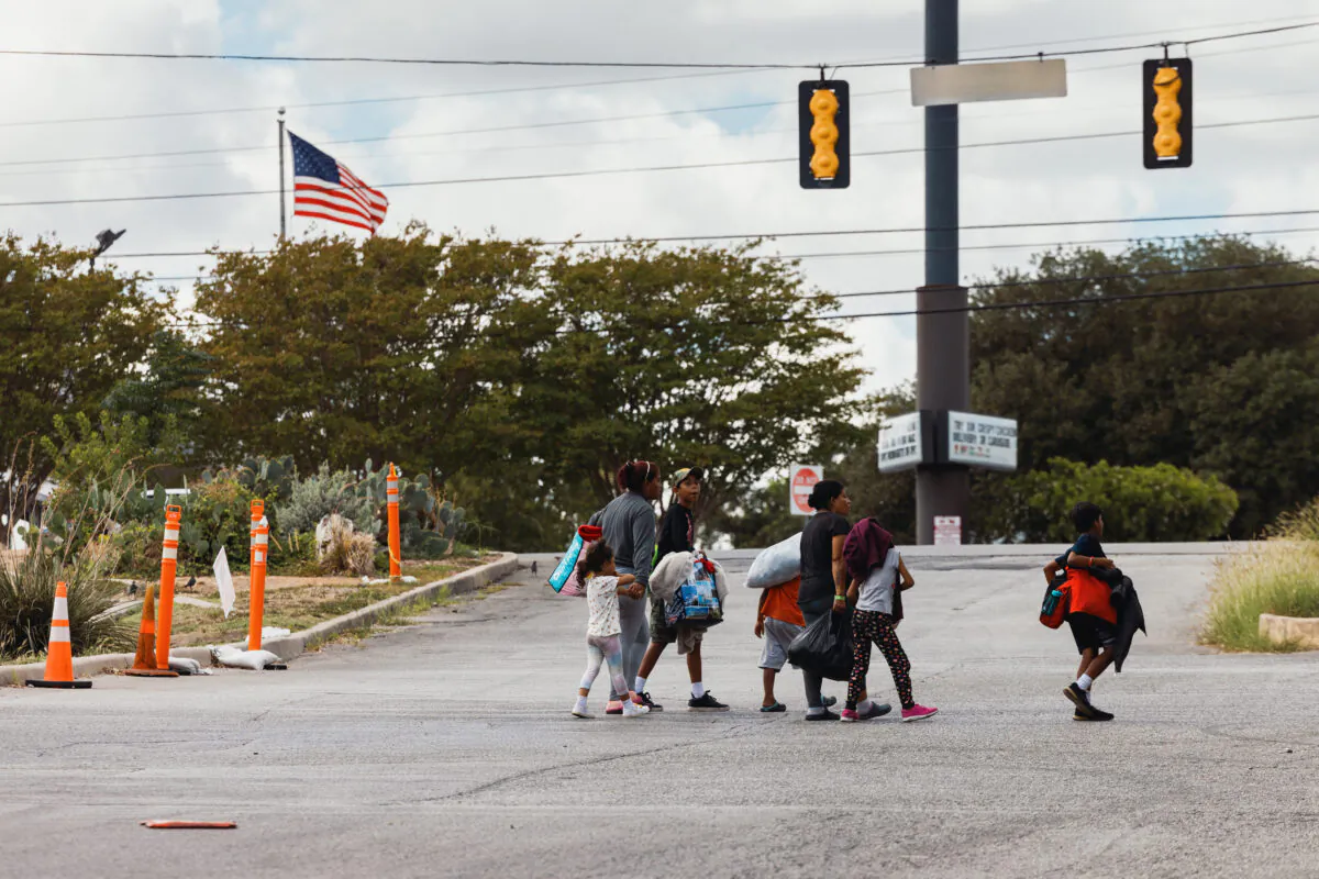 A group of migrants walk from the Migrant Resource Center to a nearby shopping center in search of food, in San Antonio, Texas, on Sept. 19, 2022. The City of San Antonio Migrant Resource Center is the origin place of two planeloads of mostly Venezuelan migrants who were sent via Florida to Martha’s Vineyard by Florida Gov. Ron DeSantis. (Jordan Vonderhaar/Getty Images)