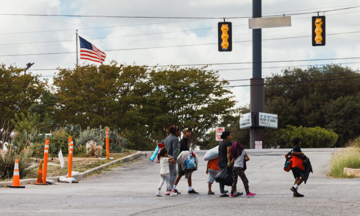 A group of migrants walk from the Migrant Resource Center to a nearby shopping center in search of food, in San Antonio, Texas, on Sept. 19, 2022. The City of San Antonio Migrant Resource Center is the origin place of two planeloads of mostly Venezuelan migrants who were sent via Florida to Martha’s Vineyard by Florida Gov. Ron DeSantis. (Jordan Vonderhaar/Getty Images)