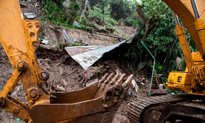 A bulldozer digs and removes debris during the search for seven people who were buried by a landslide due to the heavy rains caused by Tropical Storm Cristobal, in Santo Tomas, southern San Salvador, on June 4, 2020. (Yuri Cortez/AFP via Getty Images)