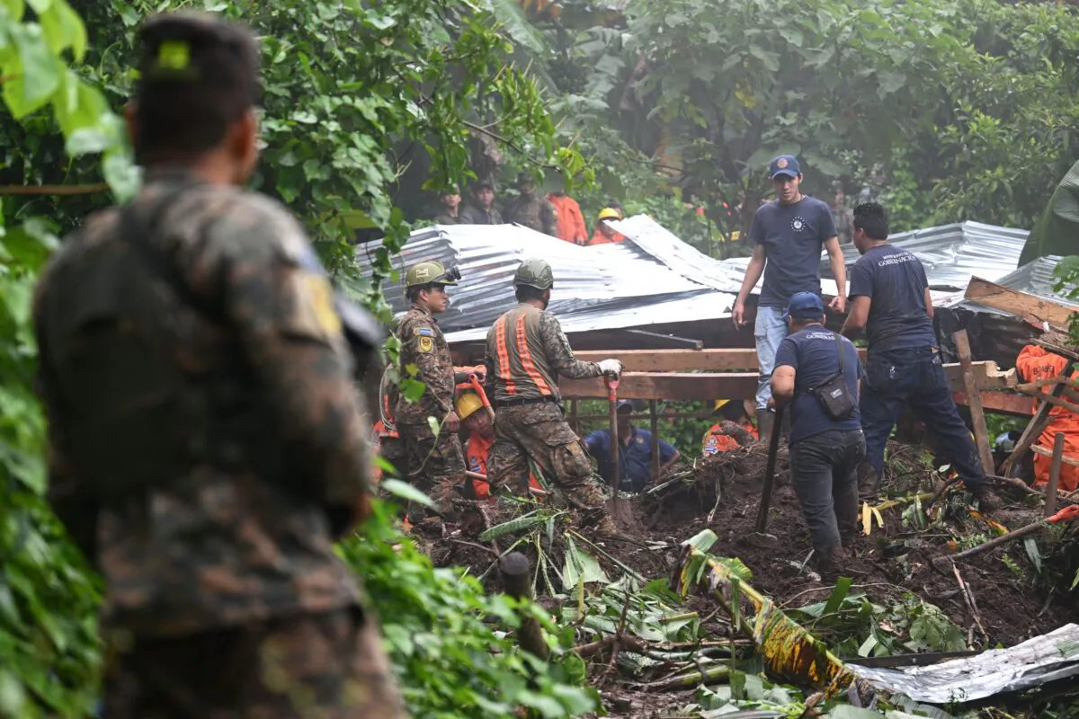Salvadorian soldiers and rescuers try to recover the bodies of five people who died after a landslide in Huizucar, El Salvador, on Sept. 22, 2022. (Marvin Recinos/AFP via Getty Images)
