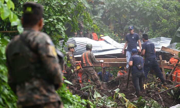 Salvadorian soldiers and rescuers try to recover the bodies of five people who died after a landslide in Huizucar, El Salvador, on Sept. 22, 2022. (Marvin Recinos/AFP via Getty Images)