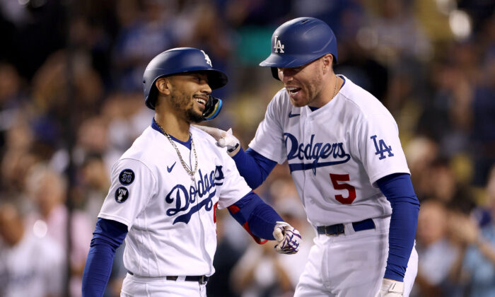 Mookie Betts (50) of the Los Angeles Dodgers celebrates his solo home-run with Freddie Freeman (5) during the fourth inning at Dodger Stadium in Los Angeles, on Sept. 21, 2022. (Harry How/Getty Images)