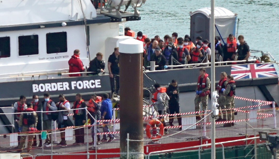 A group of illegal immigrants are brought in to Dover, Kent, from a Border Force vessel following a small boat incident in the English Channel, on Sept. 22, 2022. (Gareth Fuller/PA Media)
