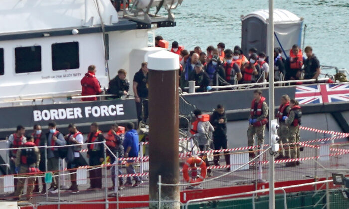 A group of illegal immigrants is brought in to Dover, Kent, from a Border Force vessel following a small boat incident in the English Channel, on Sept. 22, 2022. (Gareth Fuller/PA Media)