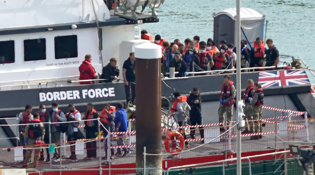 A group of illegal immigrants are brought in to Dover, Kent, from a Border Force vessel following a small boat incident in the English Channel, on Sept. 22, 2022. (Gareth Fuller/PA Media)