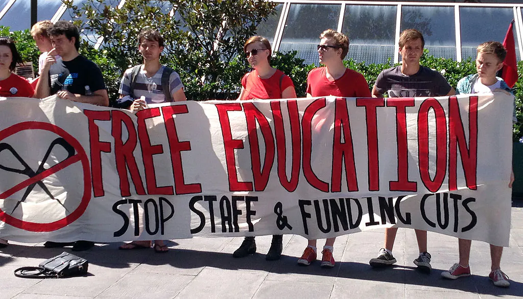 University students hold a banner during a protest rally in Sydney, Australia, on March 27, 2013. (Saeed Khan/AFP via Getty Images)