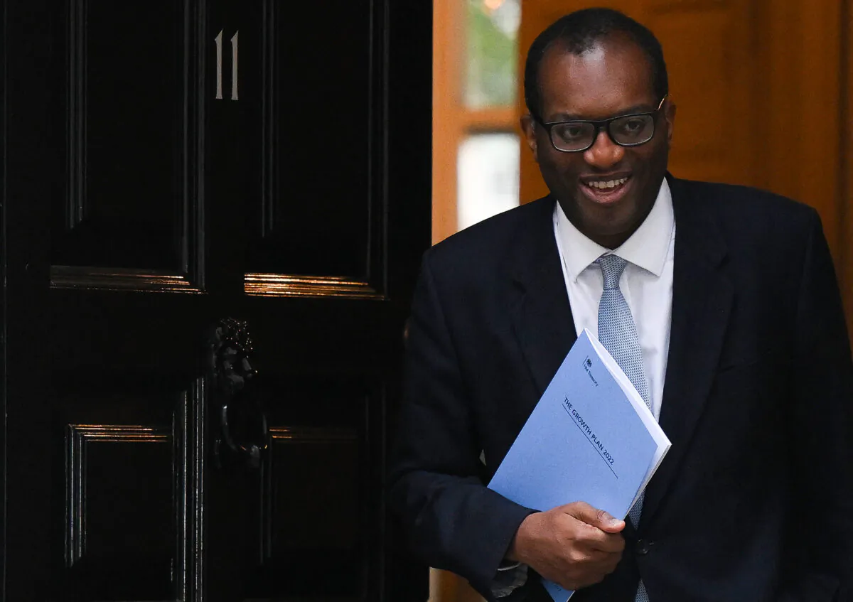 Britain's Chancellor of the Exchequer Kwasi Kwarteng holds a folder reading "The Growth Plan 2022" as he walks out of Number 11 Downing Street on his way to unveil his mini-budget in the House of Commons, in London, on Sept. 23, 2022. (Daniel Leal/AFP via Getty Images)