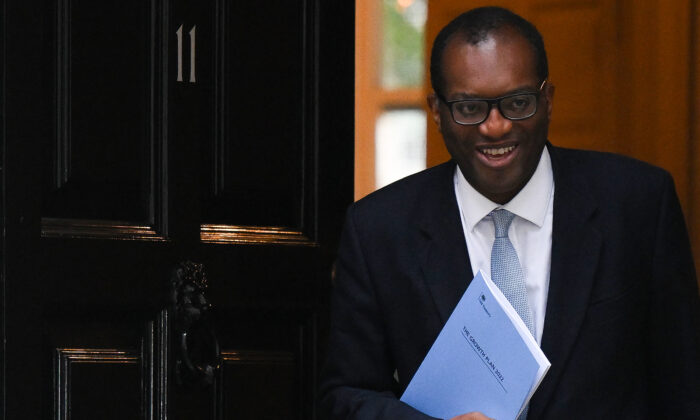 Britain's Chancellor of the Exchequer Kwasi Kwarteng holds a folder reading "The Growth Plan 2022" as he walks out of Number 11 Downing Street on his way to unveil his mini-budget in the House of Commons, in London, on Sept. 23, 2022. (Daniel Leal/AFP via Getty Images)