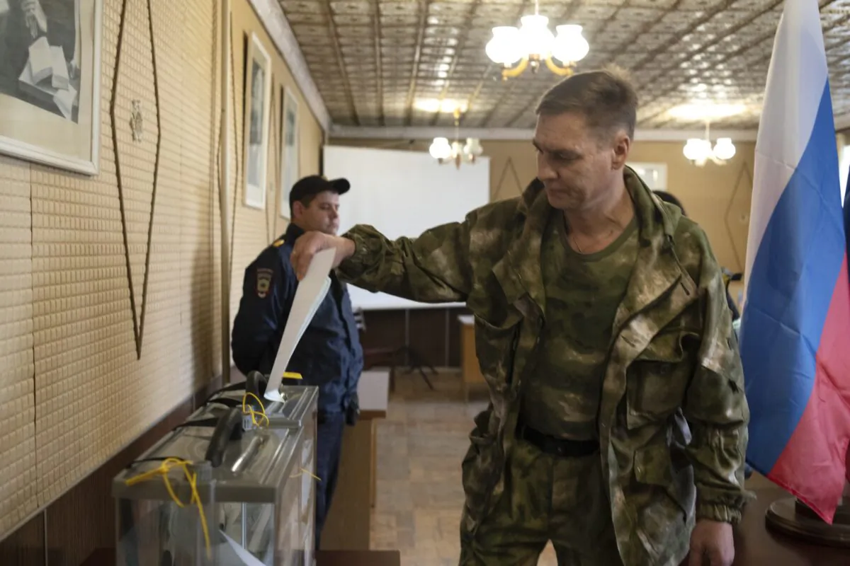 A Luhansk People's Republic serviceman votes in a polling station in Luhansk, Luhansk People's Republic, controlled by Russia-backed separatists, eastern Ukraine, on Sept. 23, 2022. (AP Photo)
