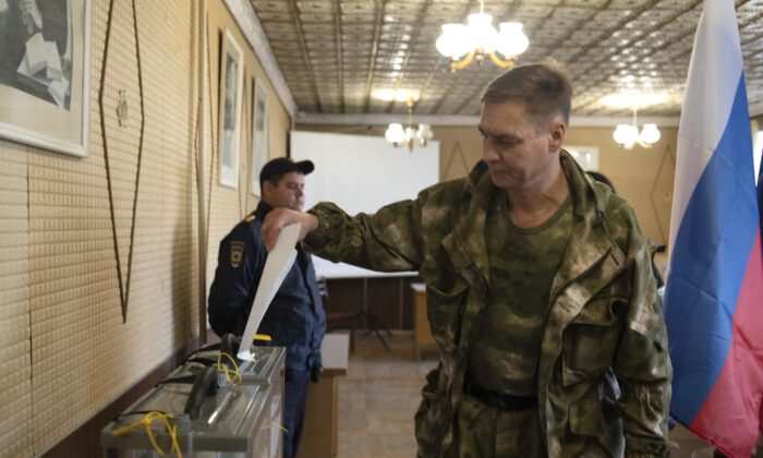 A Luhansk People's Republic serviceman votes in a polling station in Luhansk, Luhansk People's Republic, controlled by Russia-backed separatists, eastern Ukraine, on Sept. 23, 2022. (AP Photo)