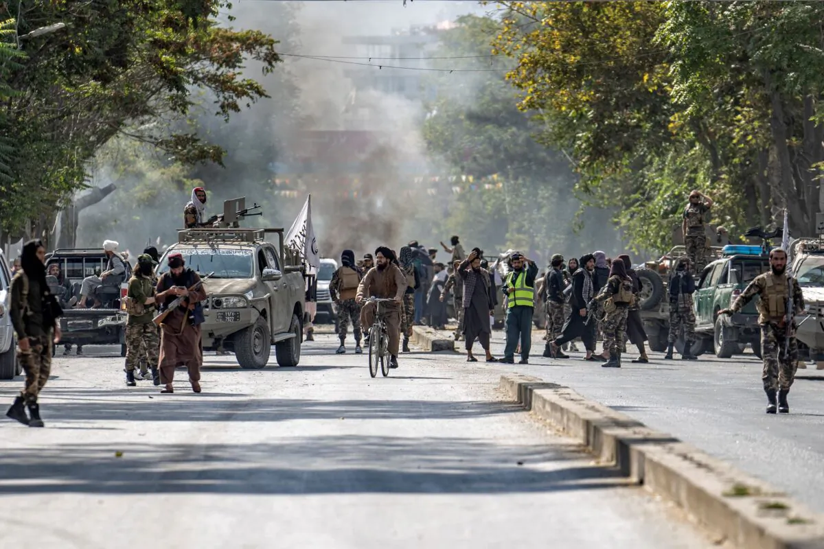 Taliban extremists stand guard at the explosion site, near a mosque, in Kabul, Afghanistan, on Sept. 23, 2022. (Ebrahim Noroozi/AP Photo)