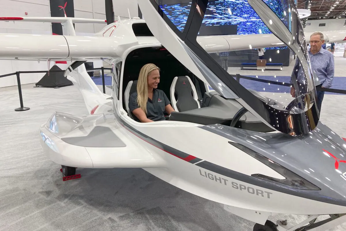Suzanne Clavette, ICON Aircraft's marketing manager and a pilot, sits in an ICON A5 aircraft on the floor of the North American International Auto Show in Detroit, on Sept. 19, 2022. (Mike Householder/AP Photo)