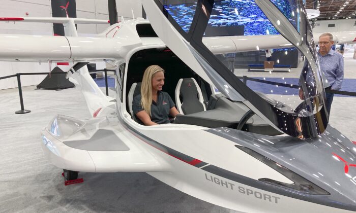 Suzanne Clavette, ICON Aircraft's marketing manager and a pilot, sits in an ICON A5 aircraft on the floor of the North American International Auto Show in Detroit, on Sept. 19, 2022. (Mike Householder/AP Photo)