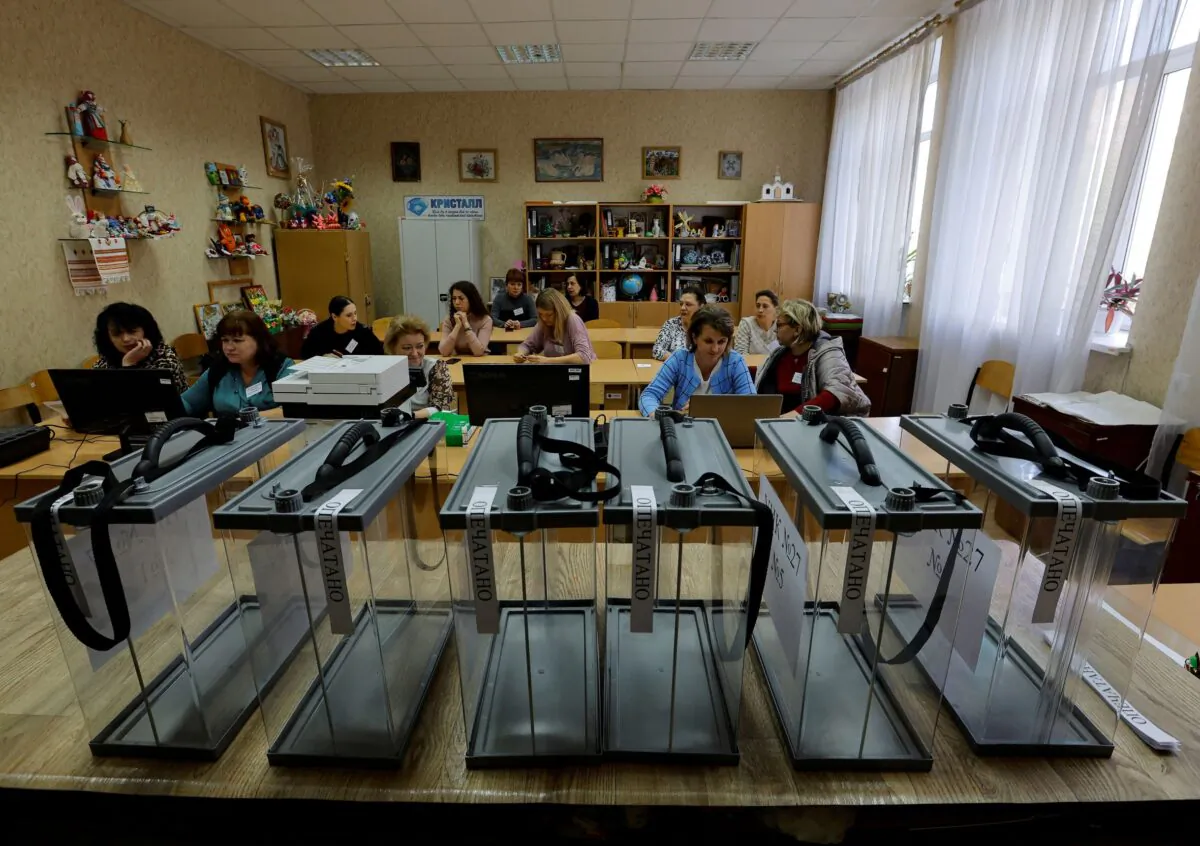Members of the local electoral commission gather at a polling station ahead of the planned referendum on the joining of the self-proclaimed Donetsk People's Republic to Russia, in Donetsk on Sept. 22, 2022. (Alexander Ermochenko/Reuters)