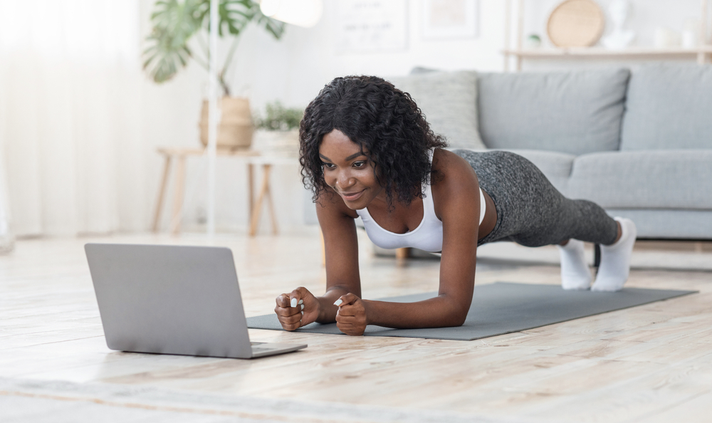 Well,Fit,Black,Girl,Planking,At,Living,Room,,Looking,At