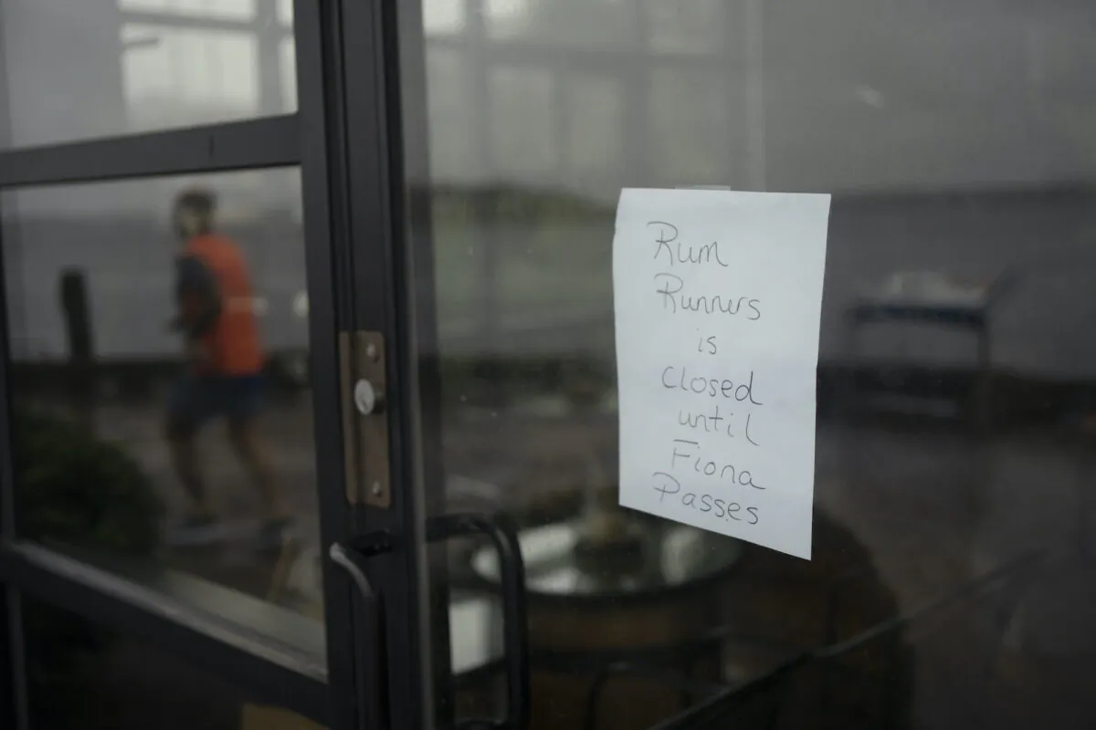 A sign in the window of a storefront on the Halifax waterfront is seen ahead of Hurricane Fiona making landfall in Halifax, on Sept. 23, 2022. (The Canadian Press/Darren Calabrese)