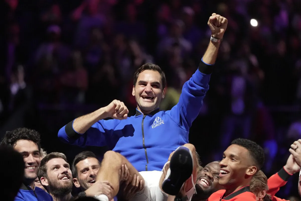 Team Europe's Roger Federer is lifted by fellow players after playing with Rafael Nadal in a Laver Cup doubles match against Team World's Jack Sock and Frances Tiafoe at the O2 arena in London on Sept. 23, 2022. (Kin Cheung/AP Photo)