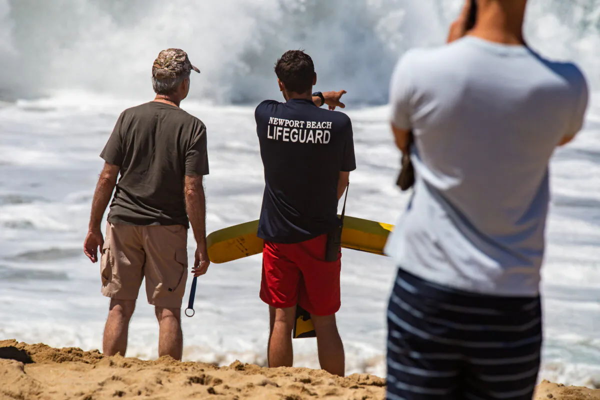 A Newport Beach Lifeguard moniters large waves at The Wedge in Newport Beach, Calif., on July 19, 2022. (John Fredricks/The Epoch Times)