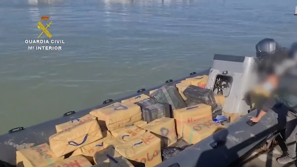 Spanish Civil Guard agents unload cargo of drugs from a fast inflatable craft at the Guadalquivir River in Cadiz, Spain, in a still from an undated video. (Spanish Civil Guard via AP/Screenshot via The Epoch Times)