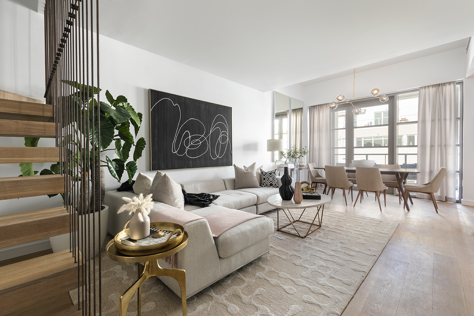A large painting helps to ground a living room, with a modern palette of black and mauve.