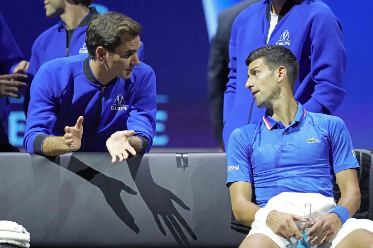 Team Europe's Novak Djokovic (R) listens to Roger Federer during a match against Team World's Frances Tiafoe on second day of the Laver Cup tennis tournament at the O2 in London on Sept. 24, 2022. (Kin Cheung/AP Photo)