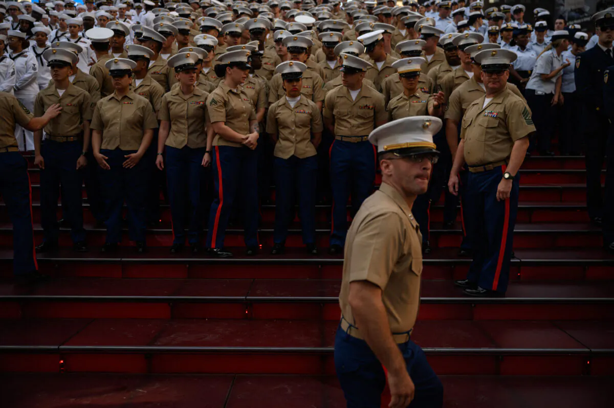 US servicemembers gather for a group photo in Times Square, as part of 'Fleet Week' celebrations in New York on May 25, 2022.(ED JONES/AFP via Getty Images)