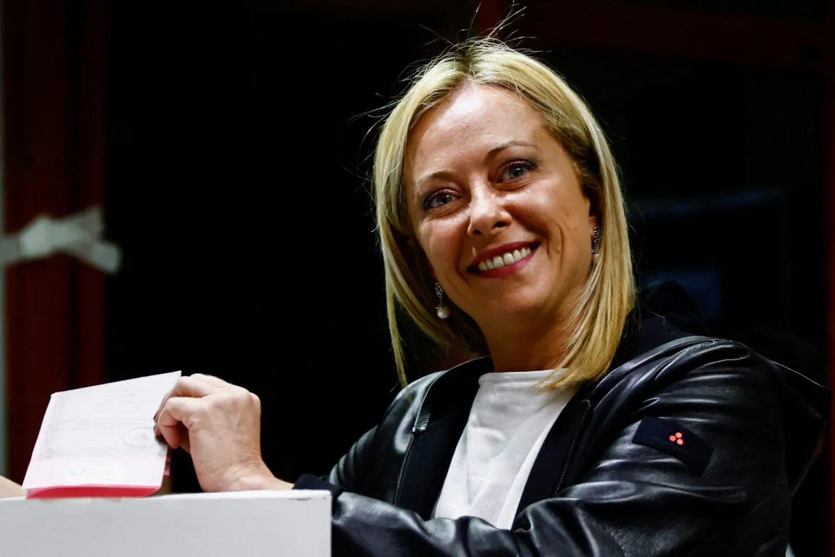 Giorgia Meloni, leader of Brothers of Italy party, poses with her ballot at a polling station during the snap election in Rome on Sept. 25, 2022. (Yara Nardi/Reuters)